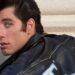 Does Travolta sing in Grease?