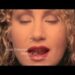 What piercing is Joan Osborne noted for having in the music video for One of Us?