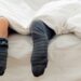 Why should we not wear socks while sleeping?